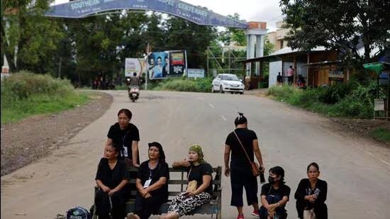 Kuki women sit on a bench as they guard a checkpoint on a road in Churachandpur district in the northeastern state of Manipur. (REUTERS File)
